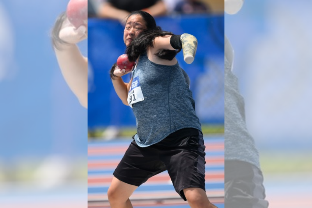 Danielle Kanas competing in shot put at a track and field competition.