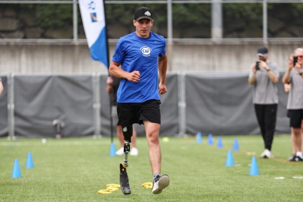 Adaptive athlete with a lower limb prosthesis runs through a drill marked by training cones during a Challenged Athletes Foundation and Össur adaptive running clinic.