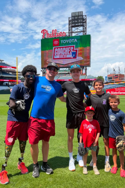 Adaptive athletes, coaches, and youth participants pose for a photo on the field at Citizens Bank Park during the Toyota Phillies Coaches Clinic.