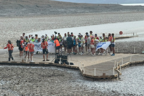 Runners, crew members, and event staff gather near Badwater Basin before the start of the Badwater Ultramarathon in Death Valley National Park.