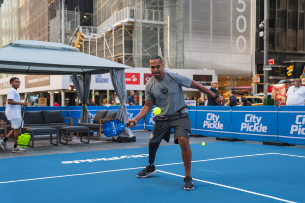 Adaptive athlete returns a pickleball during a clinic session on a CityPickle court in Times Square, New York City.