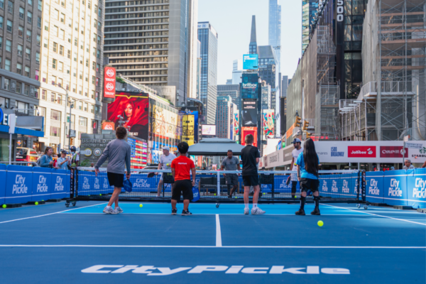 Participants rally on a CityPickle pickleball court during a Challenged Athletes Foundation adaptive sports clinic in Times Square.