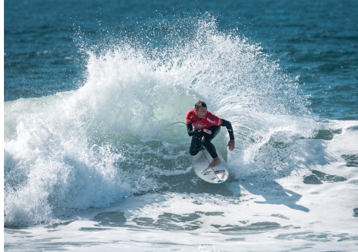 Ant Smyth surfing a wave during a para surfing competition.