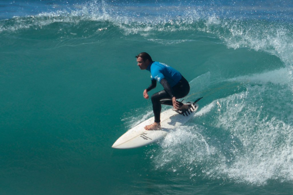 Ant Smyth surfing a wave while riding inside the barrel.