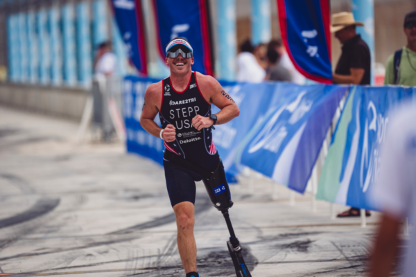 Athlete wearing a lower-limb prosthesis participates in an adaptive sports training clinic focused on movement, fitness, and performance.