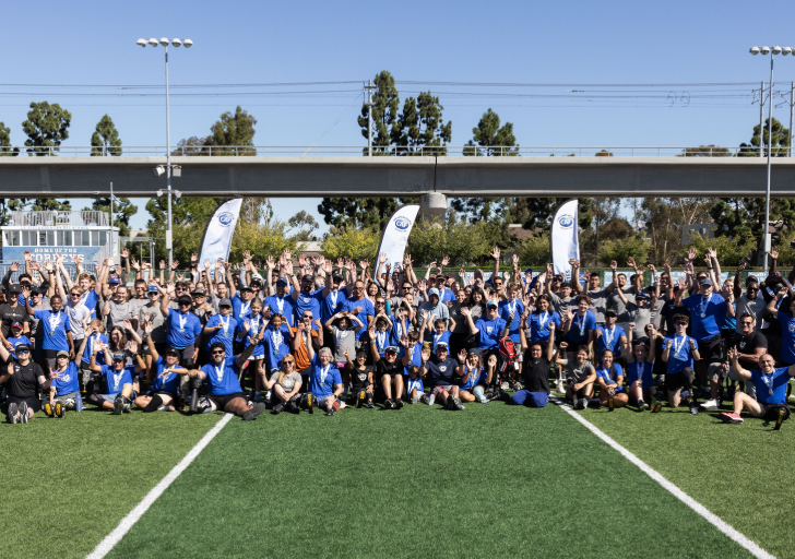 Challenged Athletes Foundation athletes and community members gather on the field during adaptive sports clinics ahead of SDTC 2026.