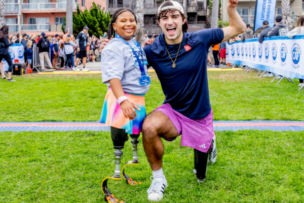 Adaptive athlete celebrates with a fellow participant after completing a Challenged Athletes Foundation community race event.